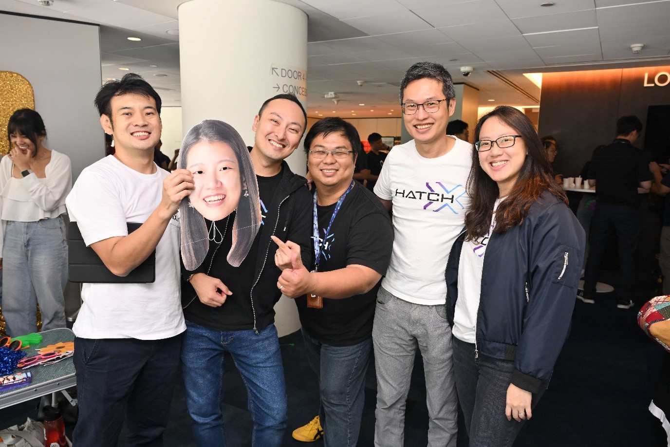 A group of people smiling at an event.