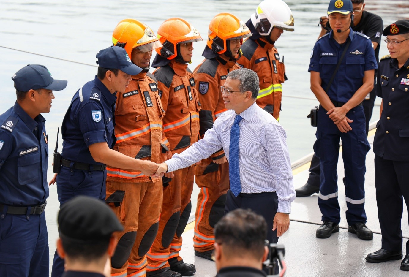 Man shaking hands with a group of men.
