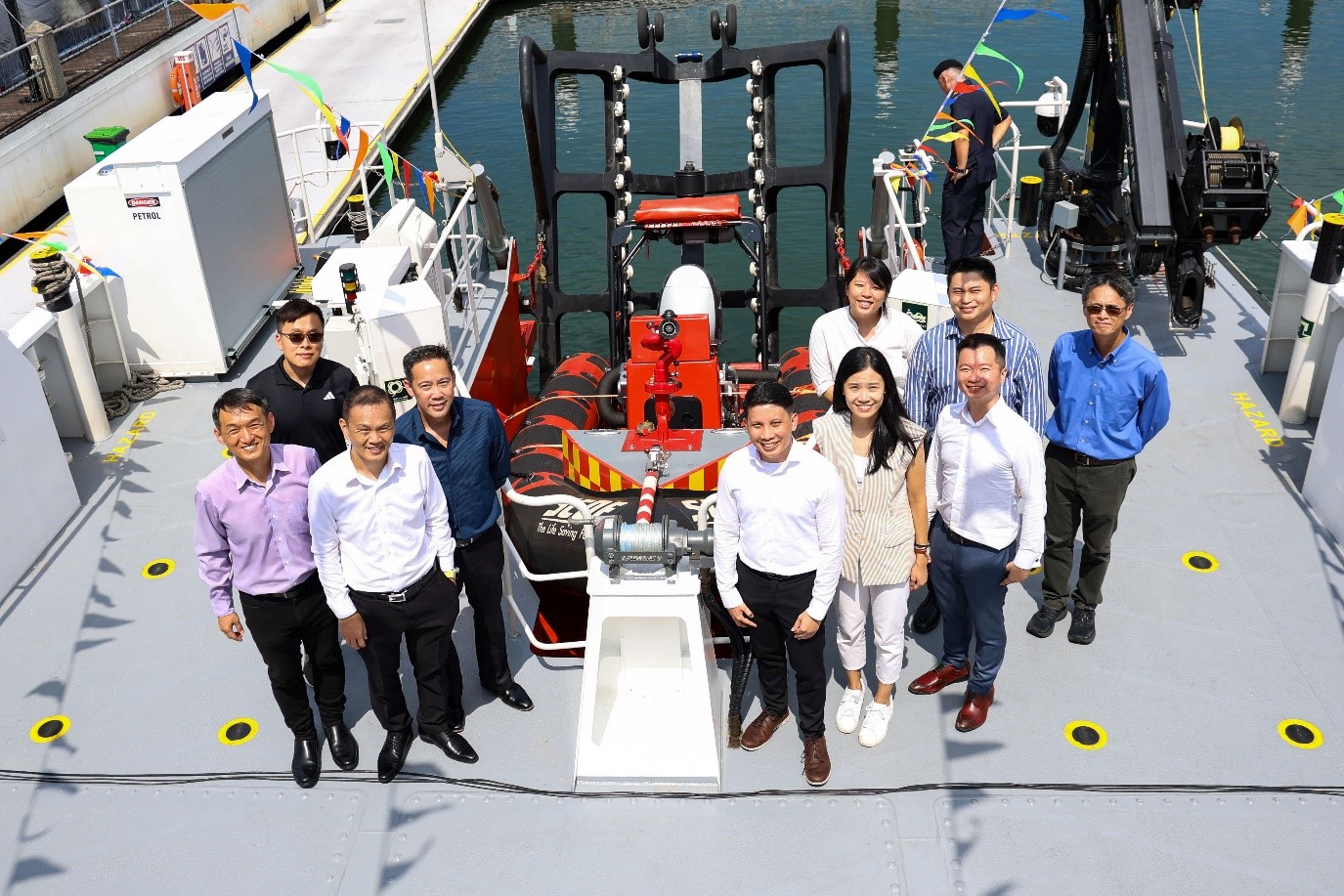 Group of people standing on the deck of a ship.