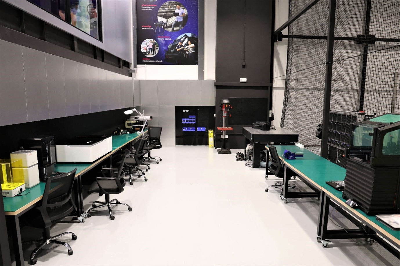 A room with tables and chairs and equipment on the tables.