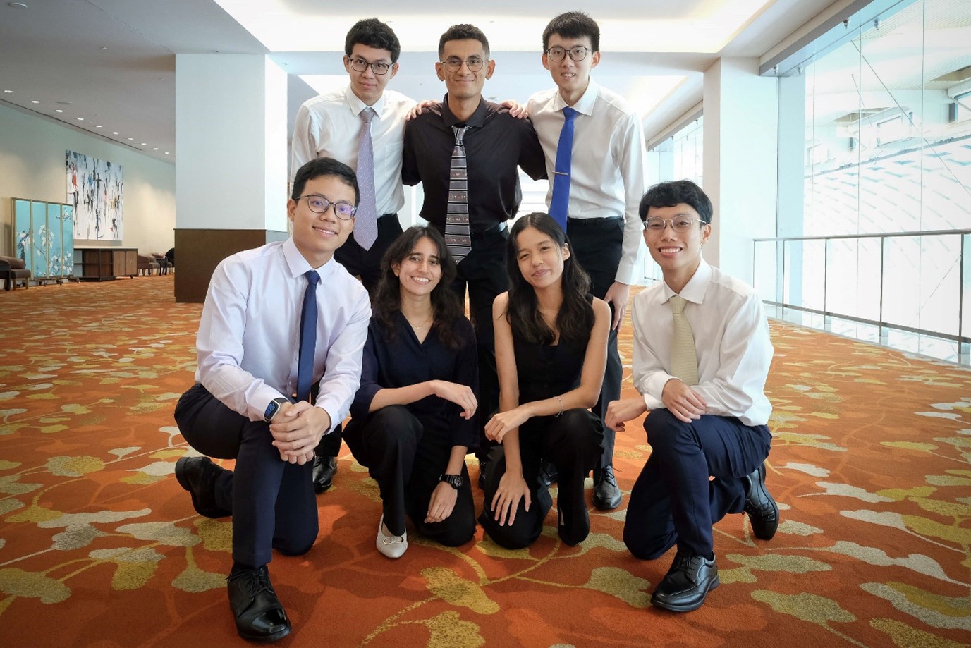 Five young men and two young women posing for a photo.