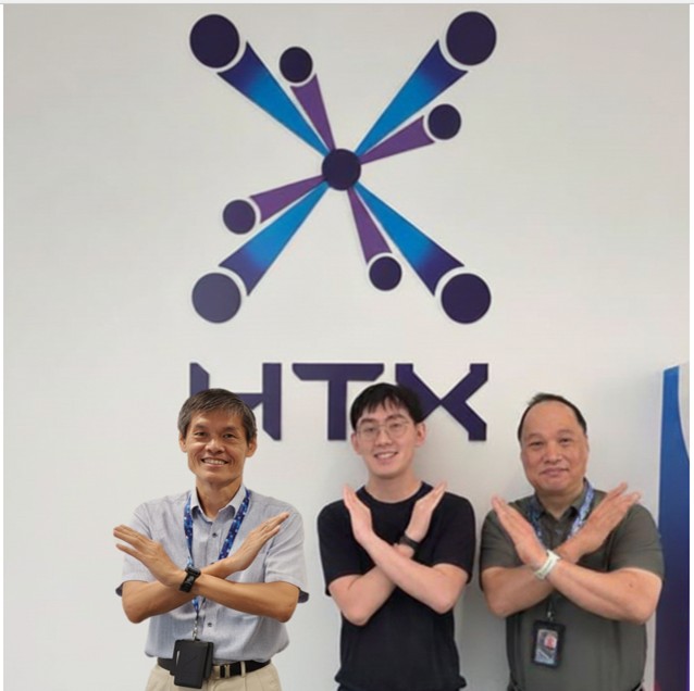 Three men standing in front of a wall with HTX’s logo, all posing with their arms crossed in an 'X' shape.