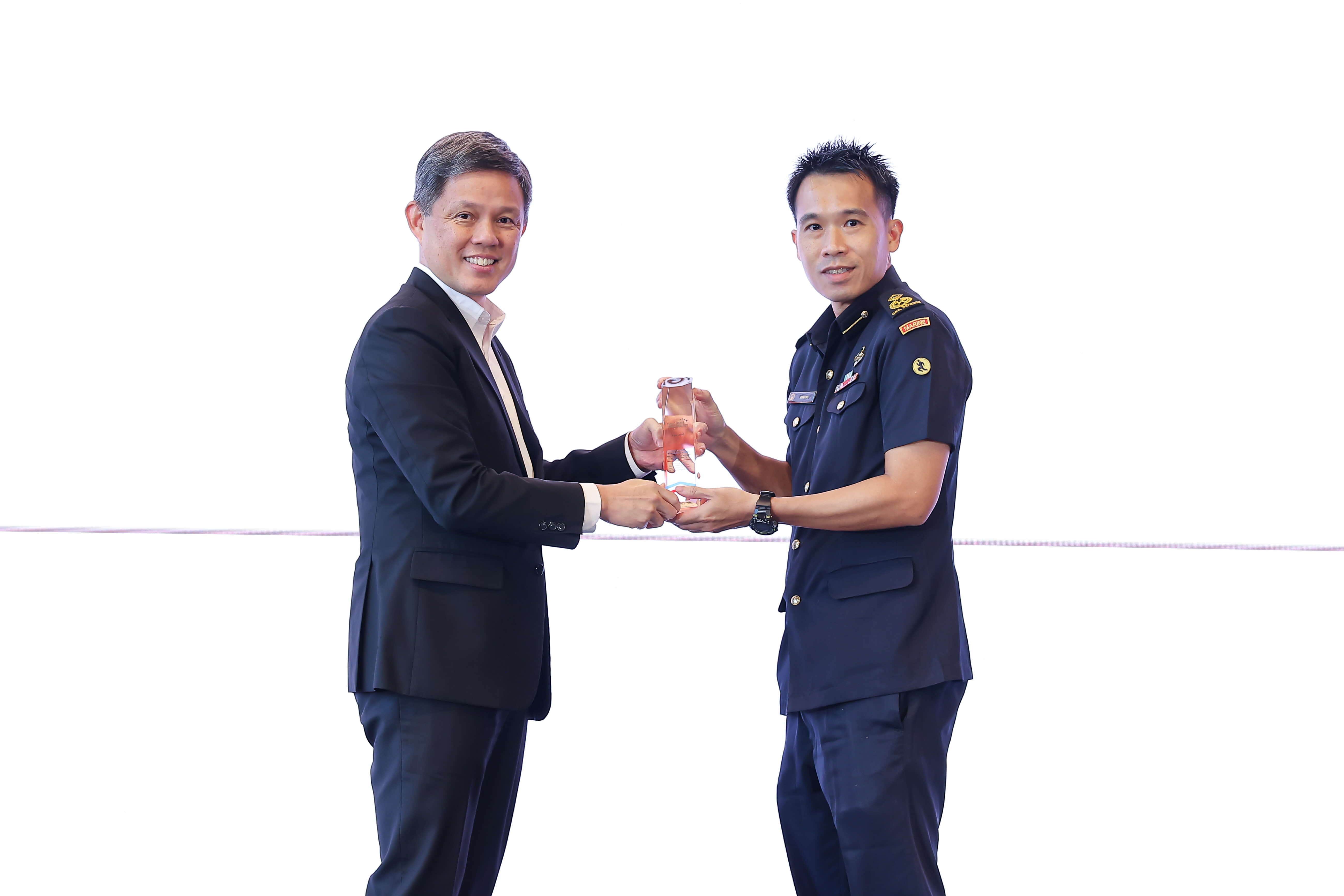 One man giving an award to another man.