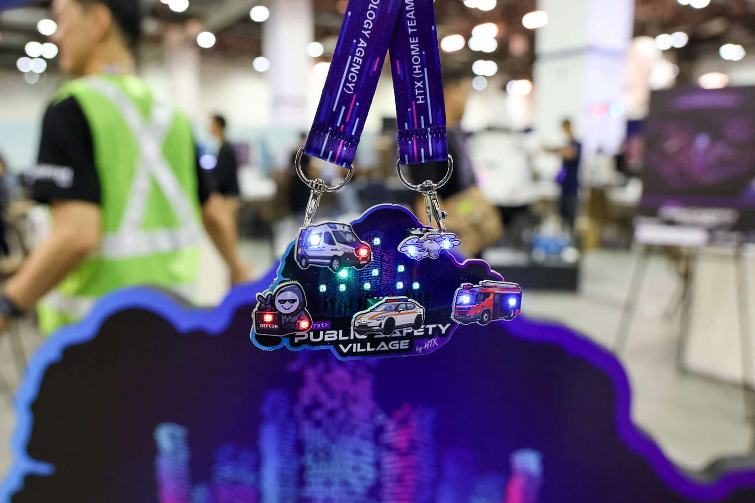 Public Safety Village badge featuring illuminated icons of emergency vehicles.