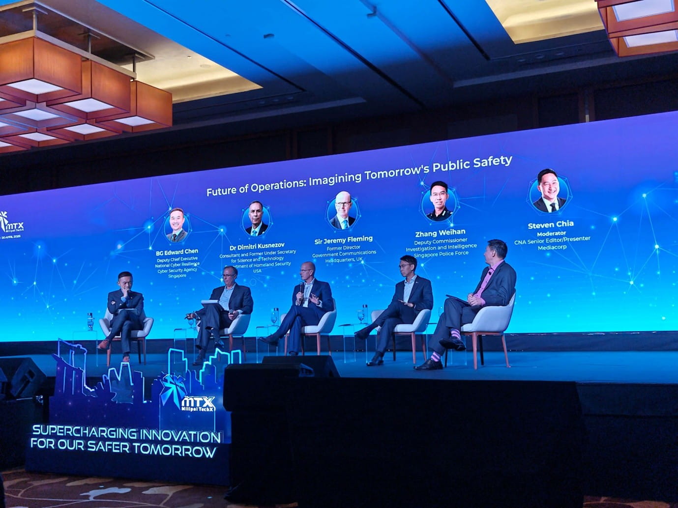 Group of people on stage for a panel discussion.
