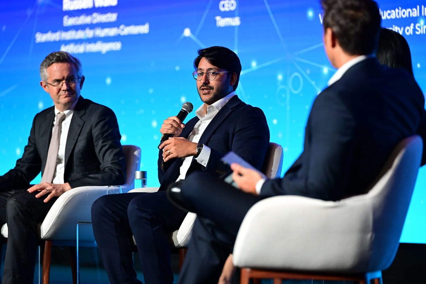Man speaking at a panel discussion.