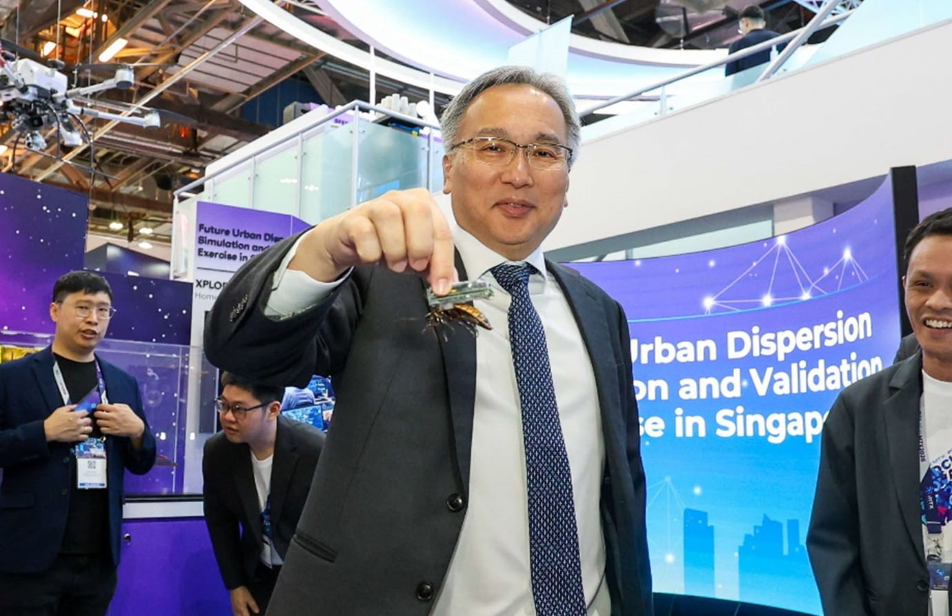 A man holds an insect-hybrid robot.