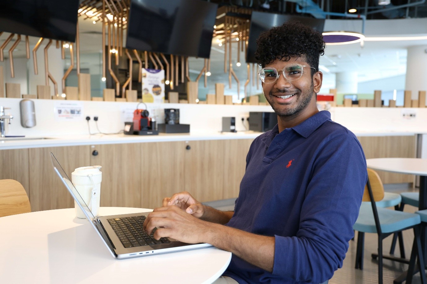 A man sitting with an open laptop